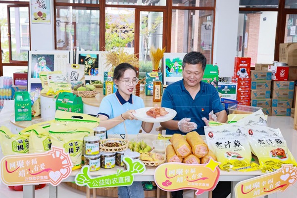 ?季西村黨支部副書記丁偉（右）介紹老汁雞。盛義攝