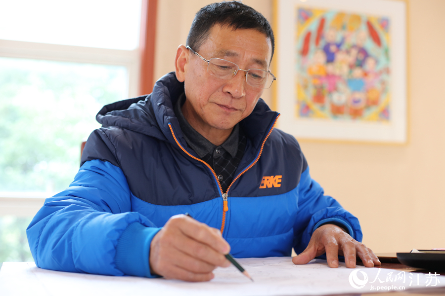  農(nóng)民畫畫家在作畫。人民網(wǎng) 冷金明攝