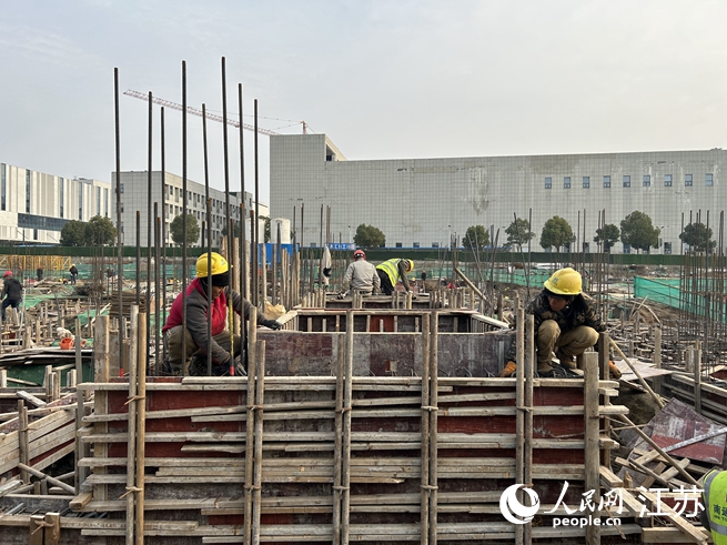 項目現(xiàn)場工人正在搭模板。人民網(wǎng) 王丹丹攝
