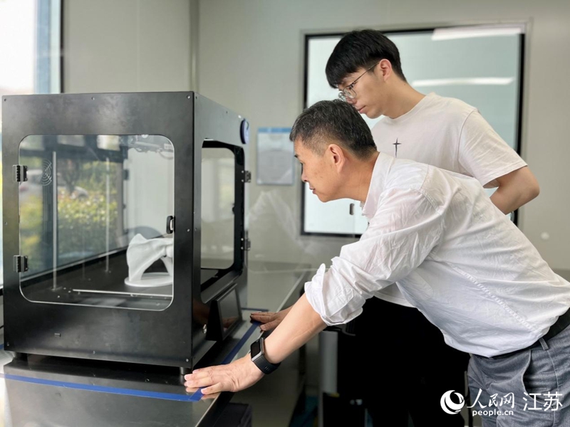 朱紀(jì)文與研發(fā)人員根據(jù)患者傷勢(shì)“打印”生物骨骼。人民網(wǎng) 王雪彤?dāng)z