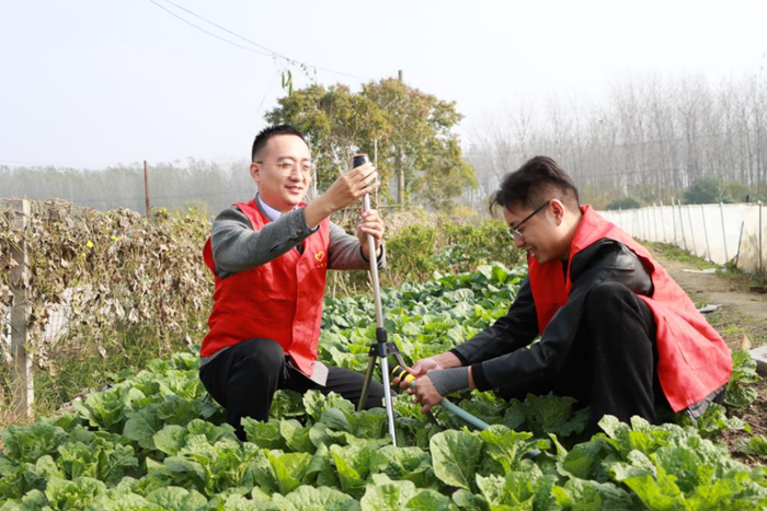 志愿者幫助村民安裝自動(dòng)灌溉設(shè)備