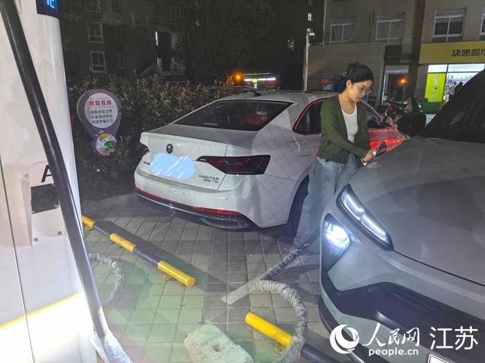 通州區(qū)金沙街道居民在為電動汽車進行充電。人民網(wǎng)記者 王繼亮攝