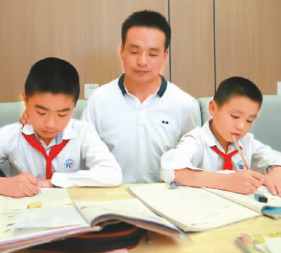 冶艾海買在照看兩個孩子寫作業(yè)。 海外網 李帛堯攝